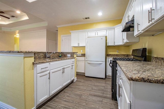 kitchen featuring white cabinets, sink, black gas stove, and white fridge