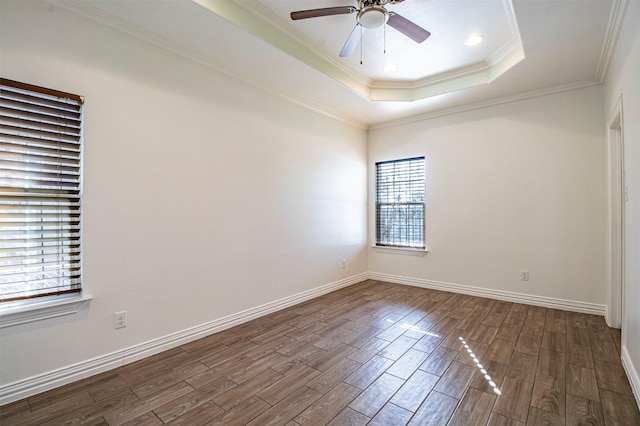 unfurnished room featuring crown molding, ceiling fan, a tray ceiling, and hardwood / wood-style floors