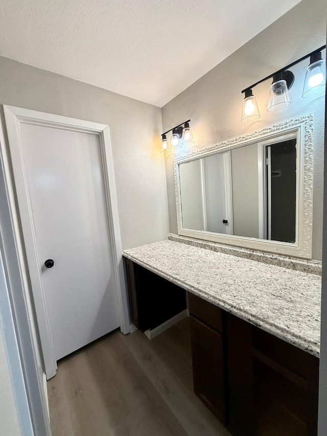 bathroom featuring hardwood / wood-style flooring and a textured ceiling