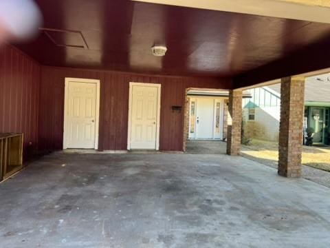 garage featuring wood walls