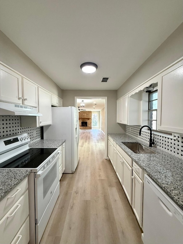 kitchen with white cabinetry, white dishwasher, sink, and electric range oven