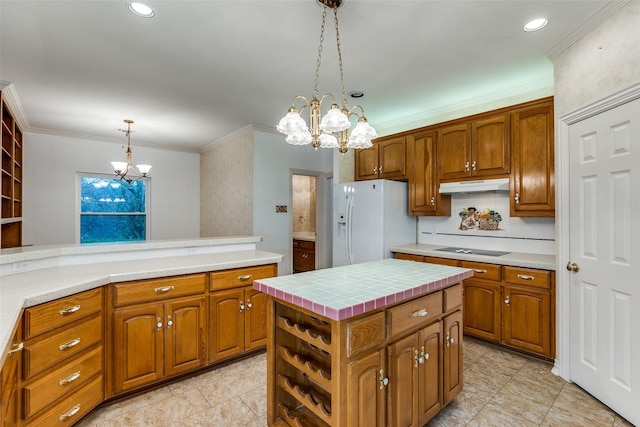 kitchen with a kitchen island, hanging light fixtures, white fridge with ice dispenser, black electric stovetop, and an inviting chandelier