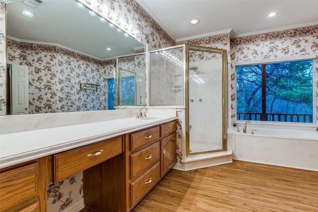 bathroom featuring vanity, crown molding, shower with separate bathtub, and hardwood / wood-style flooring