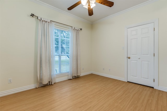 empty room with ornamental molding, ceiling fan, and light wood-type flooring