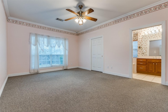 unfurnished bedroom with sink, ornamental molding, ceiling fan, light carpet, and ensuite bath