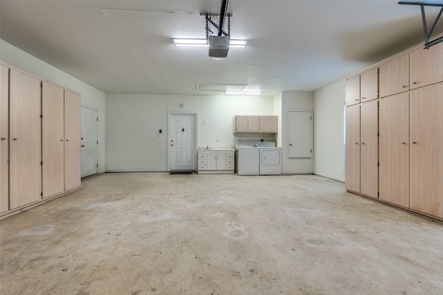 garage featuring independent washer and dryer and a garage door opener