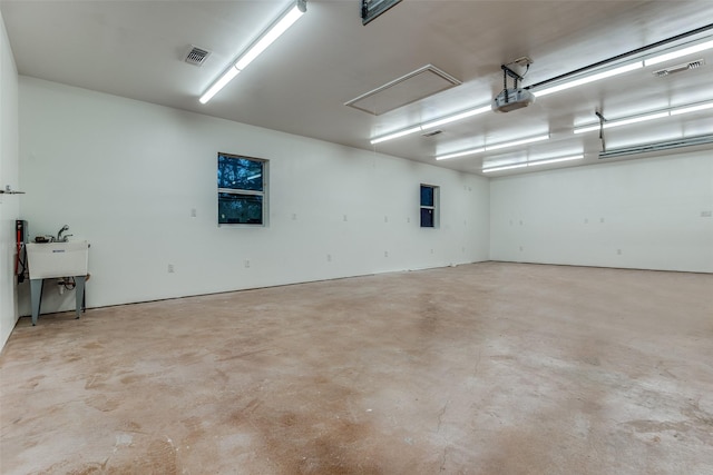 garage with a garage door opener and sink