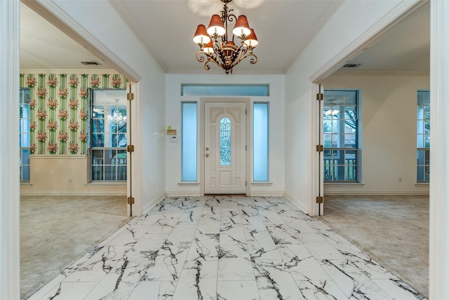 foyer entrance featuring crown molding and a notable chandelier