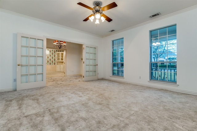 unfurnished room with ceiling fan with notable chandelier, carpet floors, and ornamental molding