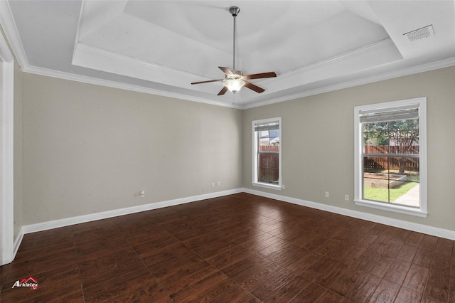 unfurnished room with dark wood-type flooring, ornamental molding, a raised ceiling, and ceiling fan