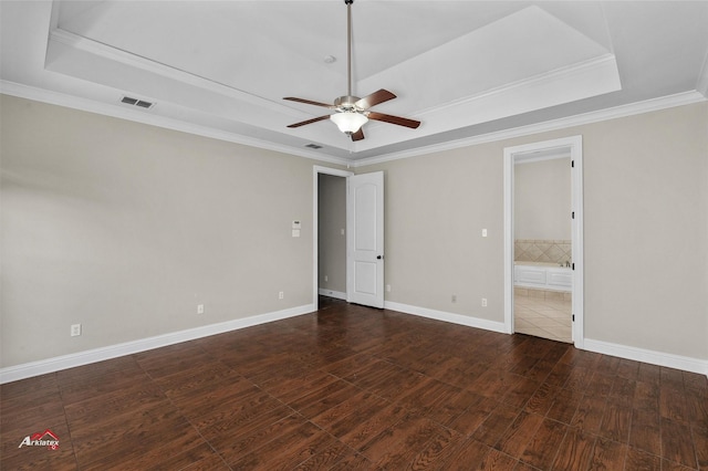 unfurnished room with dark hardwood / wood-style flooring, ceiling fan, crown molding, and a raised ceiling