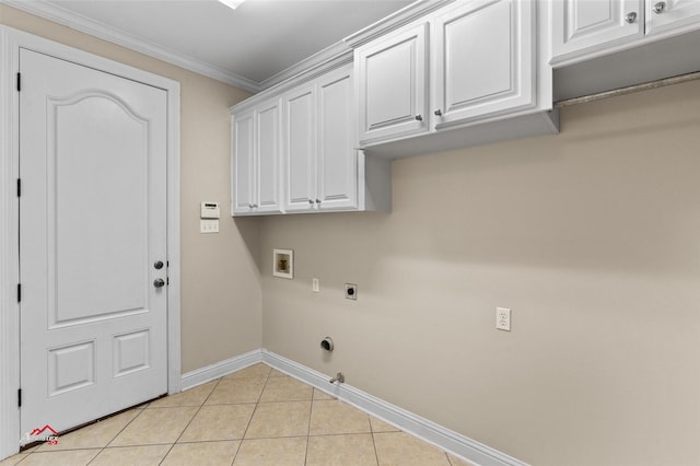 clothes washing area with crown molding, cabinets, washer hookup, light tile patterned flooring, and hookup for an electric dryer