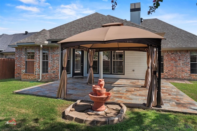 rear view of house featuring a yard, a patio, and a gazebo