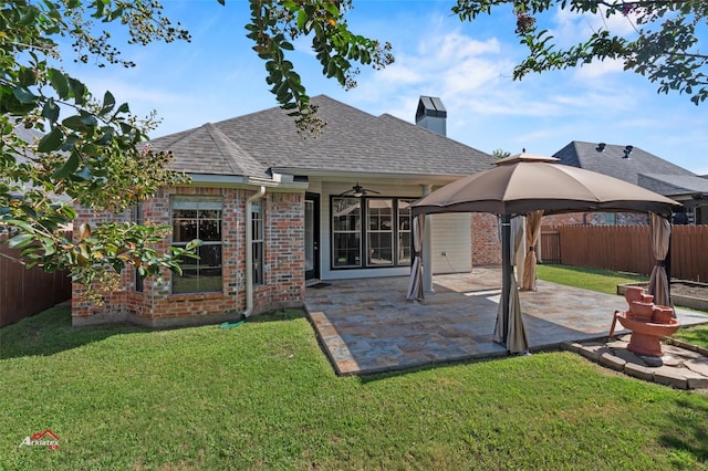 rear view of house with a yard, a patio area, and a gazebo