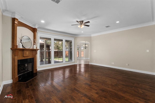 unfurnished living room with ornamental molding, dark wood-type flooring, and ceiling fan with notable chandelier