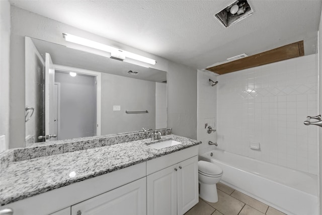 full bathroom with toilet, a textured ceiling, vanity, tiled shower / bath combo, and tile patterned flooring