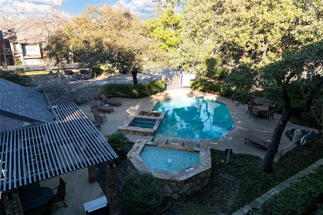 view of swimming pool featuring a patio area and an in ground hot tub