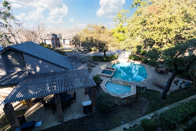 view of swimming pool with an in ground hot tub and a patio