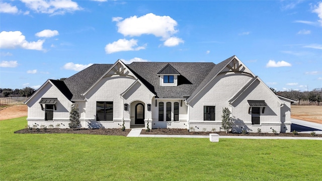 french country inspired facade featuring a front lawn