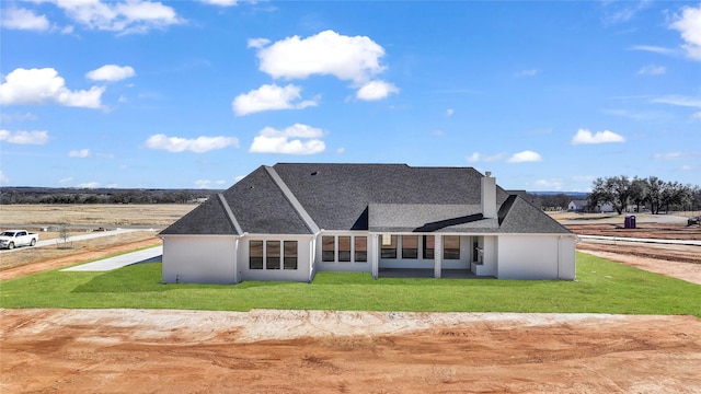 rear view of house with a lawn