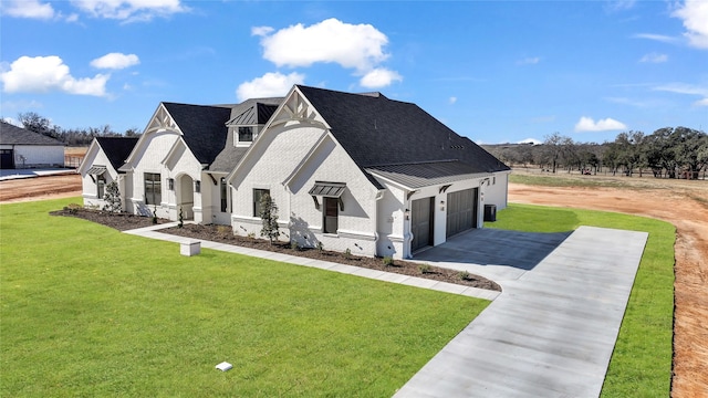 view of front of house featuring a garage and a front lawn