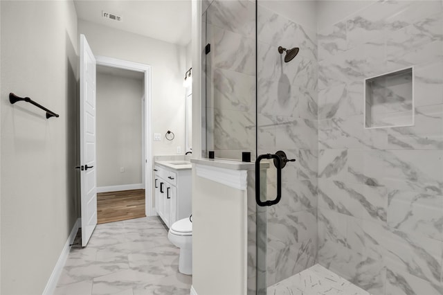 bathroom featuring walk in shower, vanity, and toilet