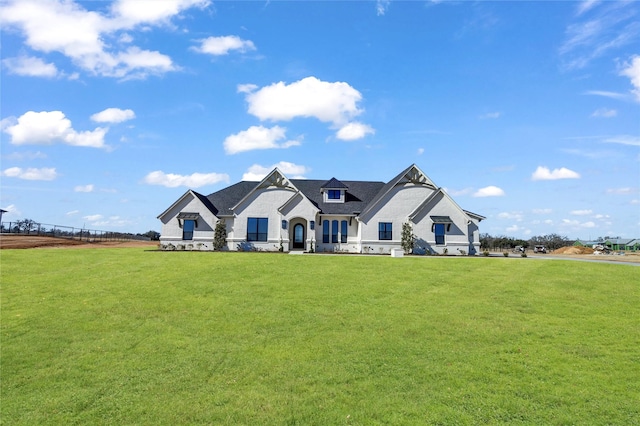 french country style house featuring a front lawn