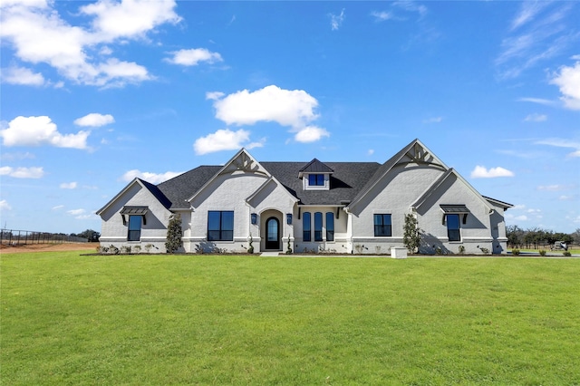 french provincial home featuring a front yard