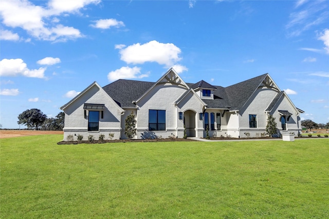 french country style house with a front yard