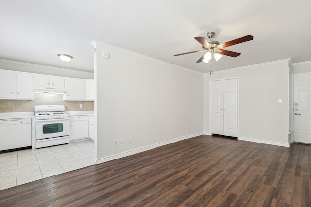 kitchen with white cabinets, decorative backsplash, ornamental molding, white appliances, and light wood-type flooring