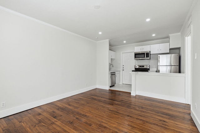 unfurnished living room with ornamental molding, sink, and dark hardwood / wood-style flooring