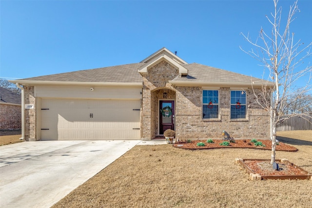 view of front of home featuring a garage and a front lawn