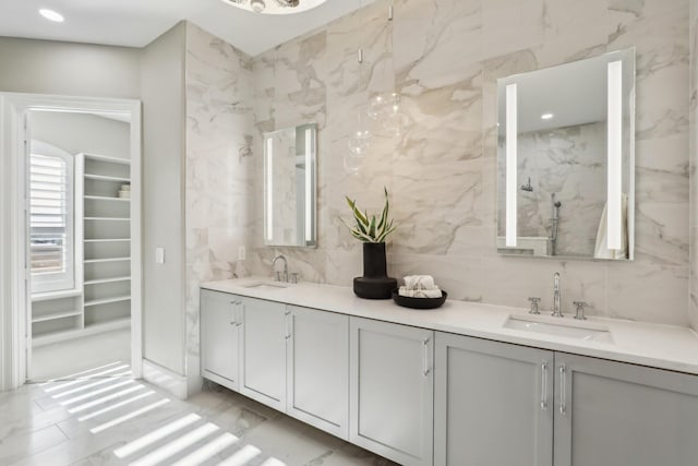 bathroom featuring vanity and tile walls