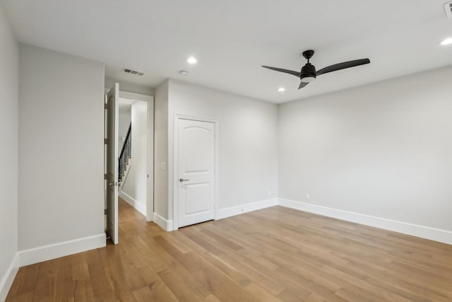 empty room featuring ceiling fan and light wood-type flooring