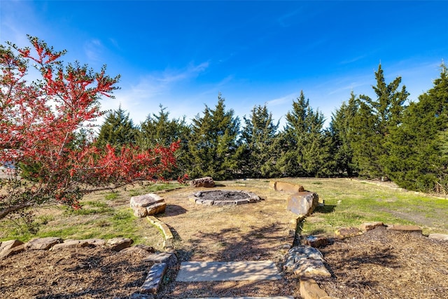 view of yard with a fire pit