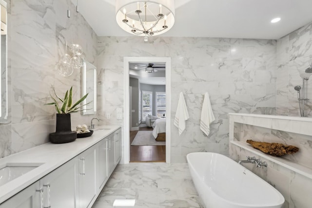 bathroom featuring vanity, a washtub, ceiling fan, and tile walls