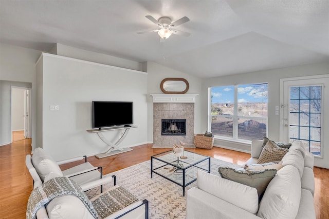 living room featuring lofted ceiling, hardwood / wood-style floors, and ceiling fan