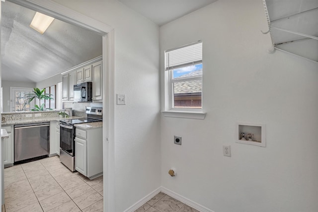 kitchen featuring light stone countertops and appliances with stainless steel finishes