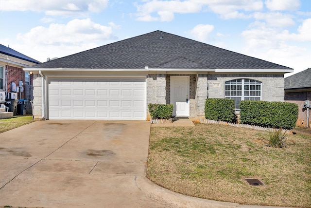 single story home featuring a garage and a front lawn