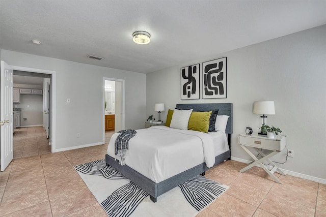 tiled bedroom featuring connected bathroom