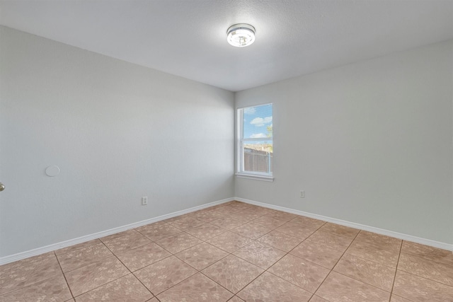 spare room featuring light tile patterned floors