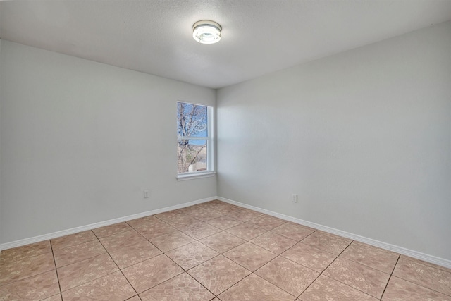 spare room with light tile patterned floors