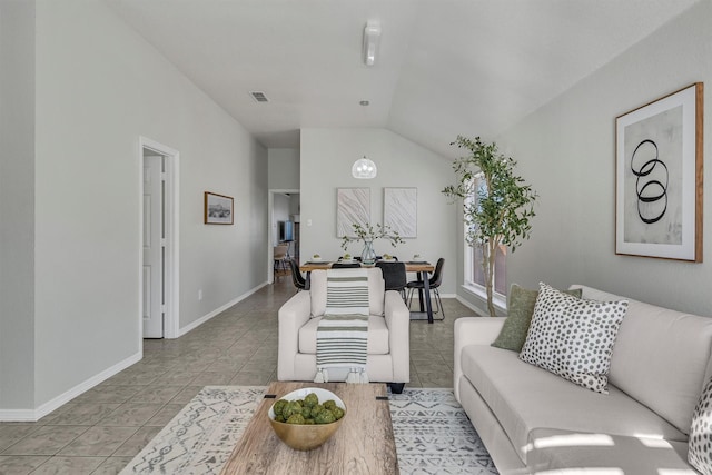 living room with light tile patterned flooring and vaulted ceiling