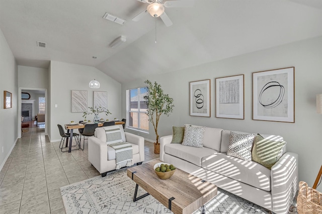 tiled living room with ceiling fan and lofted ceiling