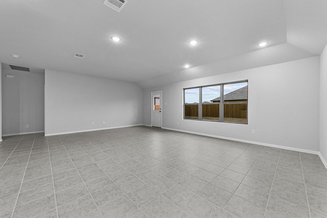 empty room featuring lofted ceiling