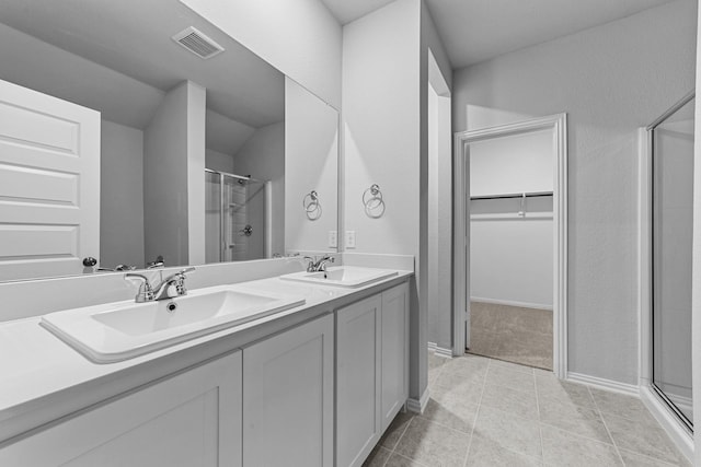 bathroom with tile patterned floors, vanity, and an enclosed shower