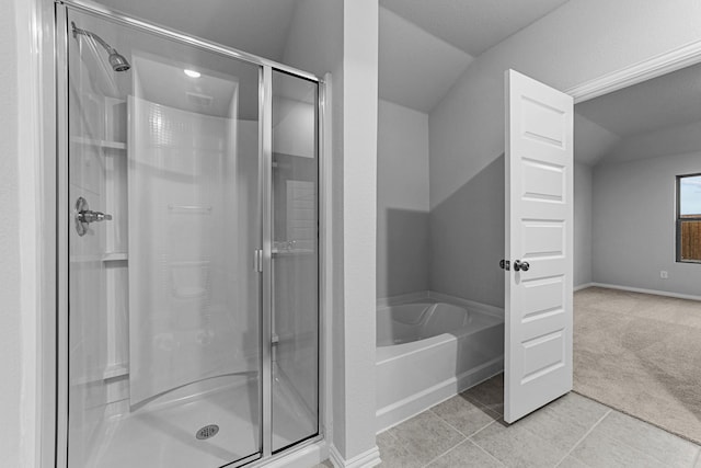 bathroom featuring tile patterned floors, shower with separate bathtub, and vaulted ceiling