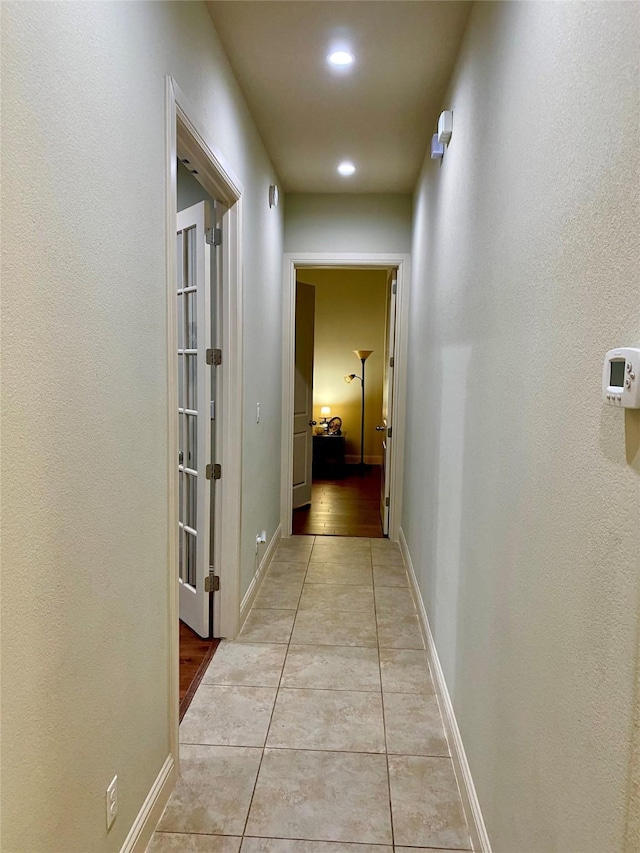 hall with light tile patterned floors