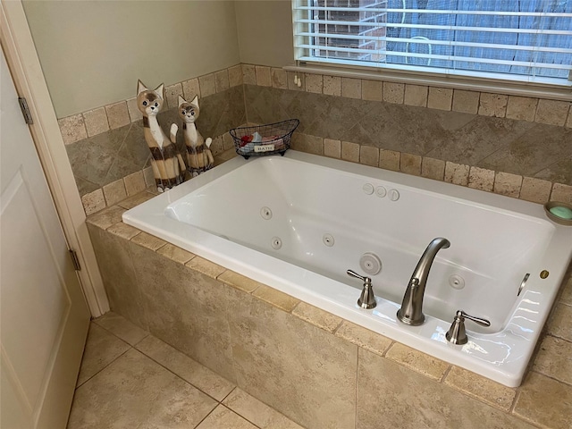 bathroom with tile patterned floors and tiled tub