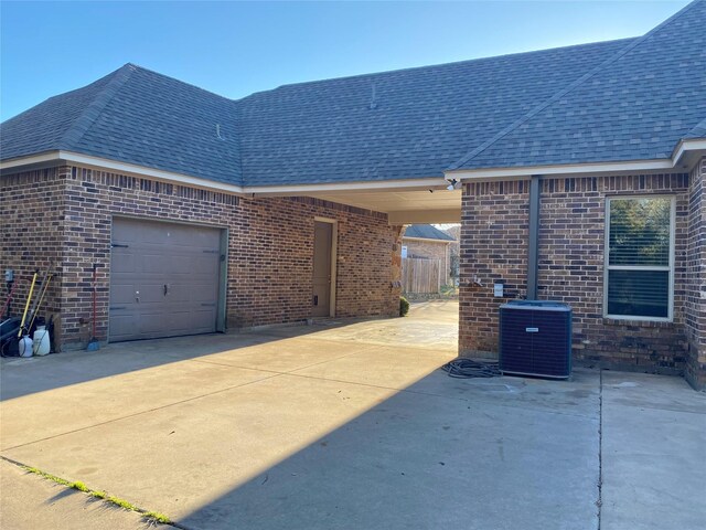 exterior space featuring central AC and a garage